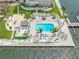 Aerial view of the community pool, cabanas, and dock with access to the waterfront at 5220 Brittany S Dr # 1409, St Petersburg, FL 33715