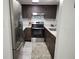 Updated kitchen with stainless steel appliances, dark wood cabinets, white subway tile backsplash and modern countertops at 5245 Amulet Dr # 208, New Port Richey, FL 34652