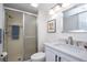 Bathroom featuring a shower with glass door, white sink, and brushed nickel faucet at 5279 Isla Key S Blvd # 313, St Petersburg, FL 33715