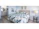Comfortable bedroom with coastal-themed bedding, side tables, and access to an en-suite bathroom at 5279 Isla Key S Blvd # 313, St Petersburg, FL 33715