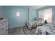 Bright bedroom with twin beds, white furniture, fish-themed bedding, and a decorative mirror at 5279 Isla Key S Blvd # 313, St Petersburg, FL 33715