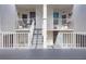 Condo entrance with stairs leading to units on the second floor with white railings and doors at 5279 Isla Key S Blvd # 313, St Petersburg, FL 33715