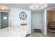 Light and airy foyer featuring a decorative clock, white cabinet, and modern lighting fixture at 5279 Isla Key S Blvd # 313, St Petersburg, FL 33715