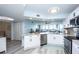 Modern kitchen featuring white cabinets, granite countertops, stainless steel appliances, and luxury vinyl flooring at 5279 Isla Key S Blvd # 313, St Petersburg, FL 33715