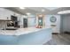 Updated kitchen with white cabinets, stainless steel appliances, granite countertops, and luxury vinyl flooring at 5279 Isla Key S Blvd # 313, St Petersburg, FL 33715