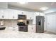 Updated kitchen with white cabinets, stainless steel appliances, and grey granite countertops at 5279 Isla Key S Blvd # 313, St Petersburg, FL 33715