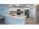 Bright kitchen with white cabinets, granite countertops, stainless steel appliances, and luxury vinyl flooring at 5279 Isla Key S Blvd # 313, St Petersburg, FL 33715