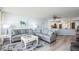 Open-concept living room featuring modern sofas, stylish decor, and seamless flow to the kitchen at 5279 Isla Key S Blvd # 313, St Petersburg, FL 33715