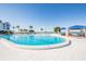 Large outdoor pool with ocean views surrounded by palm trees and lounge seating at 5279 Isla Key S Blvd # 313, St Petersburg, FL 33715