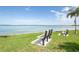 Benches overlooking a beautiful waterfront view with palm trees on a sunny day at 5279 Isla Key S Blvd # 313, St Petersburg, FL 33715