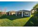 Well-maintained backyard with lush green grass and a covered lanai at 5807 Silver Sun Dr, Apollo Beach, FL 33572