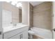 Well-lit bathroom featuring a shower-tub combination, a modern vanity, and neutral tiling at 5807 Silver Sun Dr, Apollo Beach, FL 33572