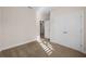 Bright bedroom with neutral walls and carpet, featuring a closet with paneled doors at 5807 Silver Sun Dr, Apollo Beach, FL 33572