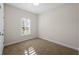 Cozy carpeted bedroom featuring a shuttered window at 5807 Silver Sun Dr, Apollo Beach, FL 33572