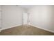 Comfortable carpeted bedroom with a door leading to other rooms at 5807 Silver Sun Dr, Apollo Beach, FL 33572