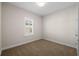 Neutral carpeted bedroom with natural light from a shuttered window at 5807 Silver Sun Dr, Apollo Beach, FL 33572