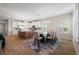 Elegant dining area with a glass table and six chairs, bathed in natural light from large windows at 5807 Silver Sun Dr, Apollo Beach, FL 33572