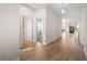 Hallway featuring wood-look flooring, leading to a bedroom and living space at 5807 Silver Sun Dr, Apollo Beach, FL 33572