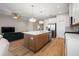 Stylish kitchen island with a sink and seating, complemented by stainless steel appliances and an open layout at 5807 Silver Sun Dr, Apollo Beach, FL 33572