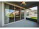 Covered patio with a ceiling fan and sliding glass doors, offering backyard views at 5807 Silver Sun Dr, Apollo Beach, FL 33572