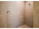 Glass enclosed shower featuring neutral tile and brushed nickel shower head at 5807 Silver Sun Dr, Apollo Beach, FL 33572