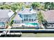 Aerial view of the waterfront property with a swimming pool and a boat dock at 615 Islebay Dr, Apollo Beach, FL 33572