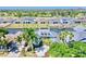 Aerial view of the two-story light blue home on the water with lush green landscaping at 615 Islebay Dr, Apollo Beach, FL 33572
