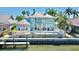 View of the home from the water with a pool and dock at 615 Islebay Dr, Apollo Beach, FL 33572