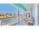 Cozy upper balcony featuring a quaint seating area and peaceful water views at 615 Islebay Dr, Apollo Beach, FL 33572