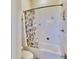 Bathroom with a shower/tub featuring white tile and stylish shell-themed curtain at 615 Islebay Dr, Apollo Beach, FL 33572