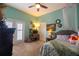 Well-lit bedroom features light-colored walls, a desk area, and comfortable furnishings at 615 Islebay Dr, Apollo Beach, FL 33572