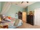 Comfortable bedroom with a ceiling fan, dresser, and personal decorations at 615 Islebay Dr, Apollo Beach, FL 33572
