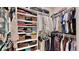 Walk-in closet with custom shelving, hanging racks, drawers, and storage for suitcases at 615 Islebay Dr, Apollo Beach, FL 33572