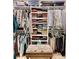 Walk-in closet with custom shelving, hanging racks, drawers, and storage for suitcases at 615 Islebay Dr, Apollo Beach, FL 33572