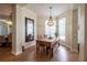Charming dining area featuring a rustic table, beaded chandelier, and plenty of natural light at 615 Islebay Dr, Apollo Beach, FL 33572