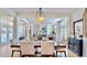 Elegant dining area with modern lighting and hardwood floors at 615 Islebay Dr, Apollo Beach, FL 33572