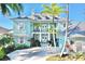 Beautiful light blue home with a second story porch, white trim and a well landscaped yard at 615 Islebay Dr, Apollo Beach, FL 33572