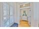 Hallway with wood floors, white walls and molding, leading to a bedroom at 615 Islebay Dr, Apollo Beach, FL 33572