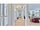Inviting hallway with wood floors, decorative lighting, and access to living spaces at 615 Islebay Dr, Apollo Beach, FL 33572