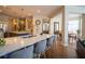 Open-concept kitchen and dining area with quartz countertops, island seating, and modern fixtures at 615 Islebay Dr, Apollo Beach, FL 33572