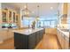Spacious kitchen with a central island, pendant lighting, stainless steel appliances, and hardwood floors at 615 Islebay Dr, Apollo Beach, FL 33572