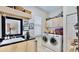 Functional laundry room with modern appliances, sink, and ample storage space at 615 Islebay Dr, Apollo Beach, FL 33572