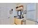 Bright laundry room features a sink, cabinets, dark countertops, and decor shelf at 615 Islebay Dr, Apollo Beach, FL 33572