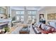 Bright living room featuring hardwood floors, a fireplace, and a white piano at 615 Islebay Dr, Apollo Beach, FL 33572