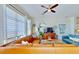 Spacious living room featuring a leather sectional, ceiling fan, and eclectic decor at 615 Islebay Dr, Apollo Beach, FL 33572
