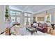 Open-concept living room with hardwood floors, a fireplace, and plenty of natural light at 615 Islebay Dr, Apollo Beach, FL 33572