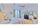 Relaxing primary bedroom with natural light, hardwood floors, and tv console at 615 Islebay Dr, Apollo Beach, FL 33572