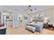 Airy primary bedroom with hardwood floors, ceiling fan, and neutral palette at 615 Islebay Dr, Apollo Beach, FL 33572