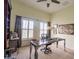 Bright office with a unique desk, ceiling fan, plantation shutters, and interesting decorative art at 615 Islebay Dr, Apollo Beach, FL 33572