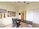 Bright office with a unique desk, ceiling fan, plantation shutters, and a closet at 615 Islebay Dr, Apollo Beach, FL 33572